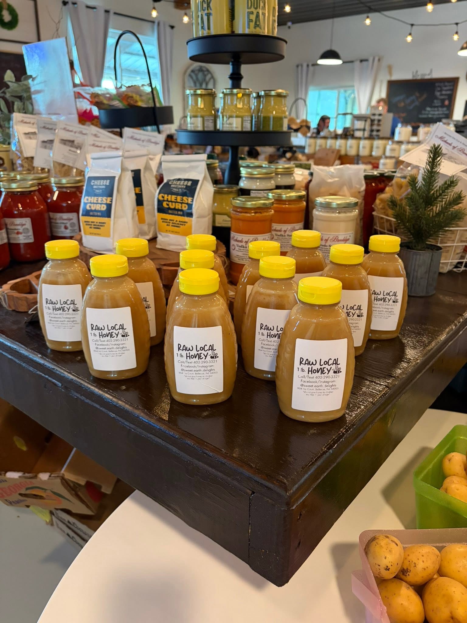 Jars of raw local honey and pantry goods on display
